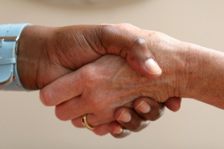 image of a an african american and caucasian shaking hands.